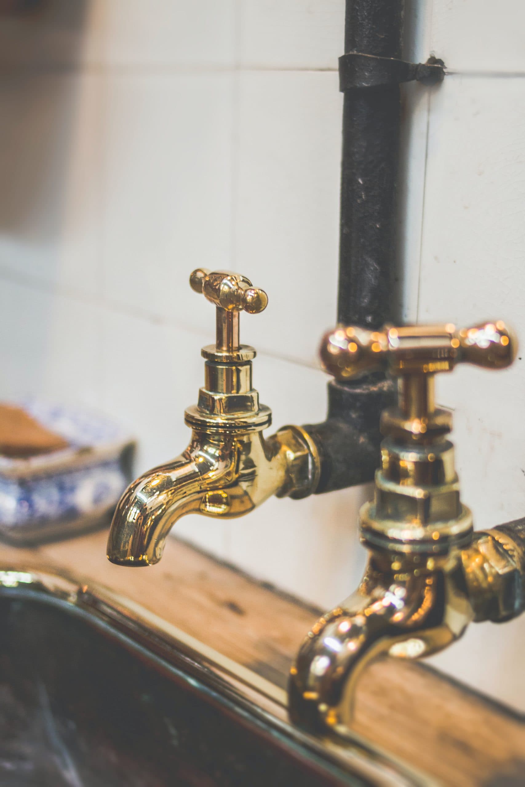 Vintage brass taps over a kitchen sink