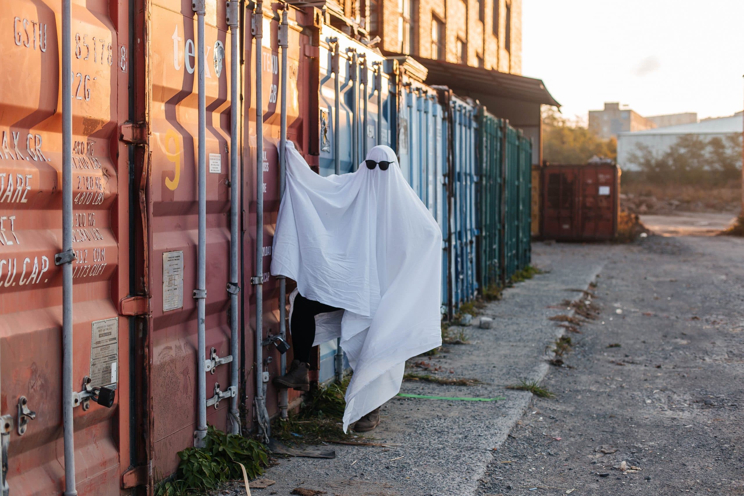 A ghost wanders around a business area outside.