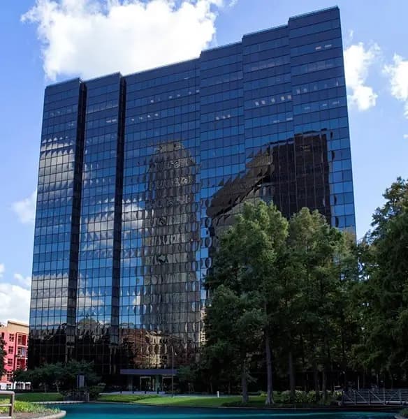 Glass tower office building with mirrored windows at 3050 Post Oak Blvd, Houston, TX, home to Opus Virtual Office.