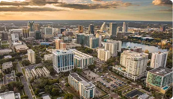 Tall office building at 200 E Robinson Street, Orlando, FL, home to Opus Virtual Office, under a cloudy sky.