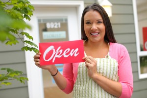 Woman holding open sign