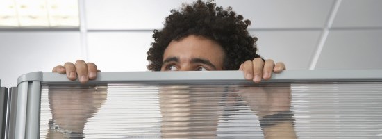 coworker looking over cubicle