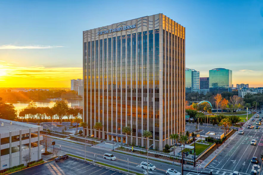 Tall office building at 200 E Robinson Street, Orlando, FL, home to Opus Virtual Office, under a cloudy sky.