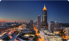 Exterior view of the Atlanta virtual office building at 3379 Peachtree Road NE, showcasing modern glass architecture and nearby high-rise buildings.