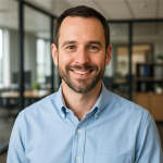 Professional man smiling in a modern office setting, representing business clients using Opus Virtual Office services.